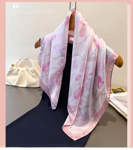 Macro view of soft tulip print and contrasting hem on pink silk-like scarf