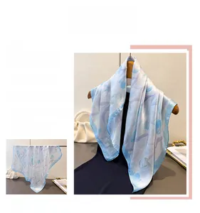 Detail of blue tulip floral silk scarf showing soft drape and elegant print textures