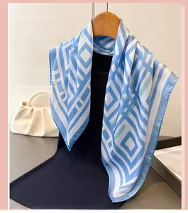 Detailed view of geometric blue and white pattern on soft faux silk square scarf accessory