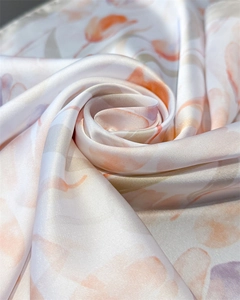 Close-up of silk-textured tulip print scarf showing smooth fabric and soft drape