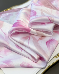 Close-up of pink tulip print on soft silk fabric showing delicate texture and luster