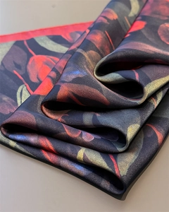 Macro shot of silk-like satin scarf with premium red tulip floral prints and glossy texture