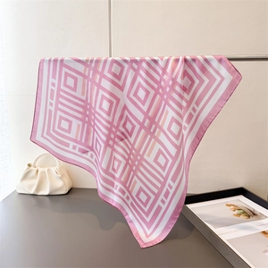 Detail of pink and white geometric grid pattern scarf with premium silky texture finish