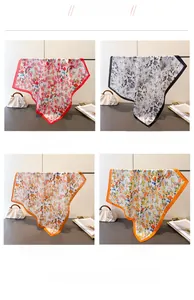 Dettaglio di quattro foulard di seta floreali in rosso, nero, arancione e blu scuro