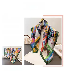 Detailed view of colorful cat print silk scarf with green border and artistic illustration