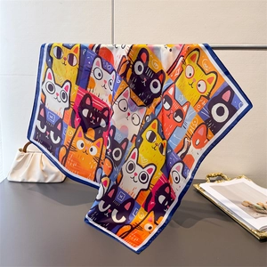 Detailed view of colorful cartoon cat print silk scarf with navy stitched edges