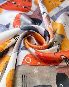 Silky scarf detail with cartoon cat print and colorful plaid pattern in soft fabric