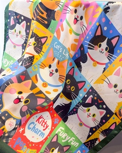 Detailed view of the cat print silk-like scarf featuring colorful blocks and patterns