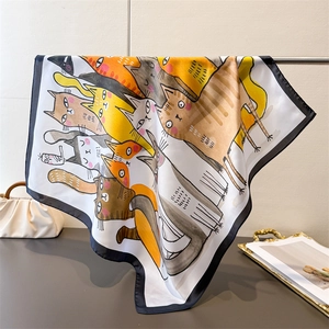 Detailed view of the silk-like scarf featuring cute cat patterns and premium draping texture