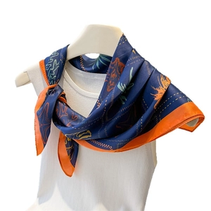 Ocean palm and tiger print silk scarf with contrast orange border on model neck