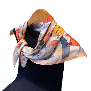 Satin silk scarf featuring colorful cartoon cat print tied on a black top