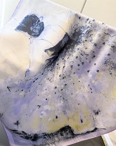 Macro detail of abstract ink painting silk scarf showing smooth texture and rolled edges