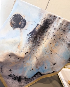 Detail of silk-like square scarf featuring artistic female silhouette and gold-toned edges