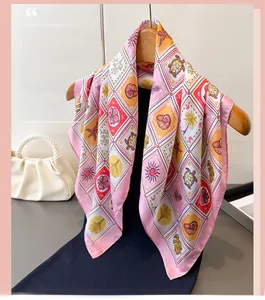 Detailed view of pink border silk scarf with nautical elements and checkered print pattern