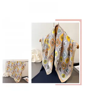 Close-up of vintage floral and geometric patterns on a beige square silk scarf
