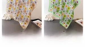 Detail of silk scarves with sea turtle shell patterns in beige and green shades