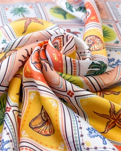 Detailed macro view of satin scarf with tropical starfish and palm leaf prints