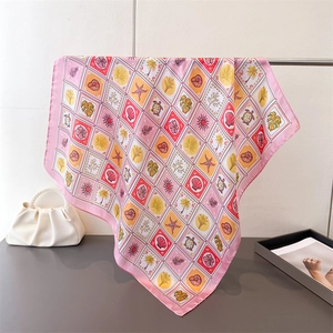 Detail of square silk scarf with tropical ocean print and elegant pink border trim