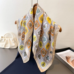 Square silk scarf with tropical ocean print and colorful geometric patterns in yellow