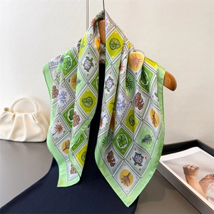 Plaid silk-feel square scarf with tropical sea turtle and leaf prints on a dress