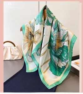 Detailed texture of elegant green floral silk scarf with soft drape and refined sheen