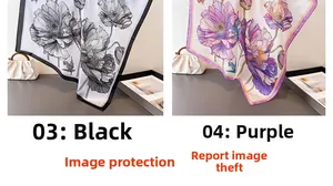 Detail view of printed silk scarves in floral patterns with black and purple borders