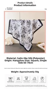 Détail d'un foulard carré en satin de qualité avec imprimé floral noir et blanc chic
