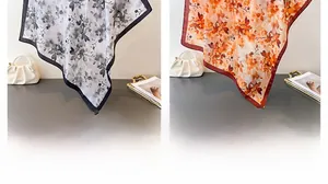 Détails de foulards en soie avec motifs floraux noirs et orange et finitions élégantes