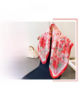 Close-up of floral and butterfly print silk scarf with luxury smooth texture