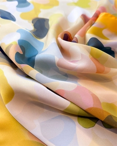 Close-up of premium silk scarf with abstract watercolor patterns and satin texture