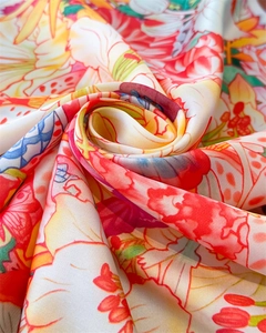 Close-up of lightweight floral silk scarf with vibrant tropical pattern and silky texture