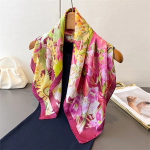 Floral print satin silk scarf with colorful sunflower pattern on wooden hanger