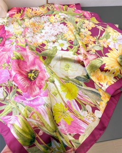 Close-up of floral pattern silk scarf with vibrant pink blossoms and deep red border