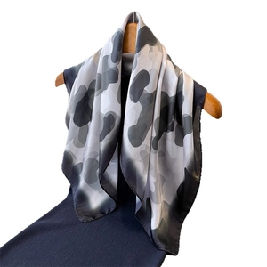 Summer lightweight silk scarf with abstract black and white camo print on hanger