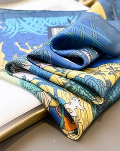 Detailed close-up of premium silk-like scarf with vibrant animal print and artistic patterns