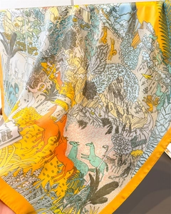 Detailed close-up of premium silk scarf featuring tropical animal and jungle print