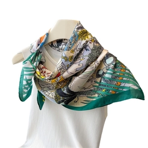 Luxurious jungle print silk scarf with elephant and tropical foliage on white backdrop