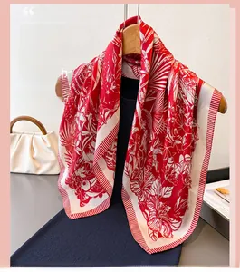 Detail of red and white floral silk scarf styled on a hanger with a black dress