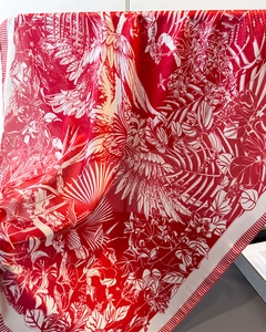 Detail of red and white silk scarf with crane and tropical floral print patterns