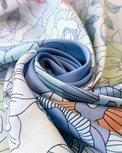 Detailed view of elegant floral silk scarf with royal blue roses and smooth texture