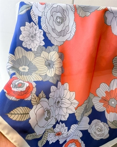 Macro shot of satin silk floral scarf with vivid orange rose print and navy details