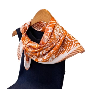 Tropical style silk-feel scarf with orange botanical leaf print and geometric patterns