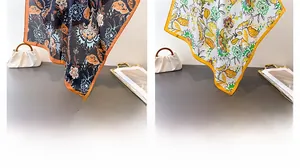 Detail view of vintage floral silk scarves in black and yellow with satin finish