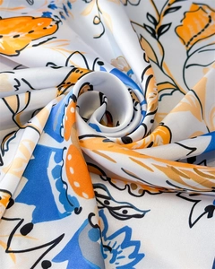 Close-up of abstract floral print silk scarf with satin luster and elegant swirl folds