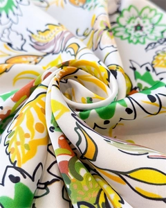 Detailed close-up showing soft silk-like fabric with vibrant lemon and floral pattern
