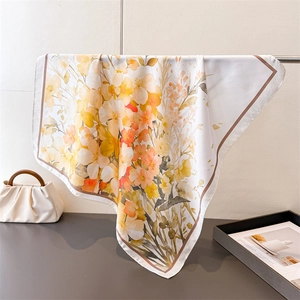 Floral silk square scarf with vibrant orange and yellow flower prints for elegant styling
