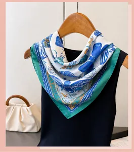 Detail view of a French silk scarf with blue butterfly and beetle prints on a hanger