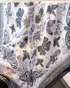 Detail of vintage French style silk scarf with black butterfly and beetle prints