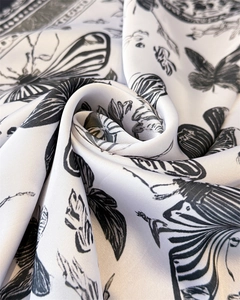 Detail showing the French butterfly print on smooth faux silk fabric texture and drape