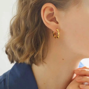 Modern gold-plated twisted hoop earrings shown on a model for a stylish daily look